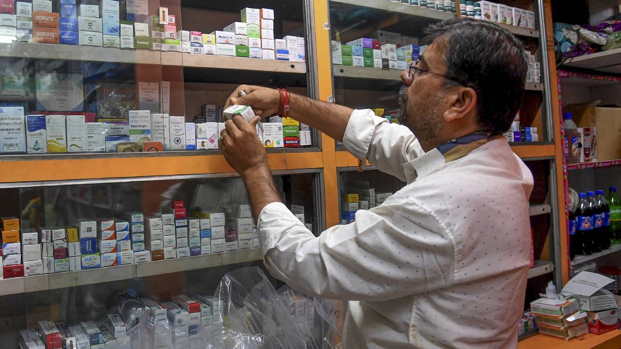 Medical store entrance with pharmacist, showing closed sign during a strike