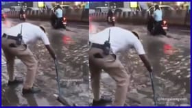 ಮಳೆಯಲ್ಲಿ ನೆನೆಯುತ್ತಲೇ ಚರಂಡಿ ಕ್ಲೀನ್ ಮಾಡಿದ ಬೆಂಗಳೂರು ಟ್ರಾಫಿಕ್ ಪೊಲೀಸ್